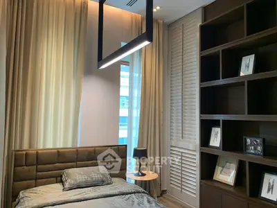 Luxurious bedroom with modern lighting and elegant shelving in a high-end apartment.