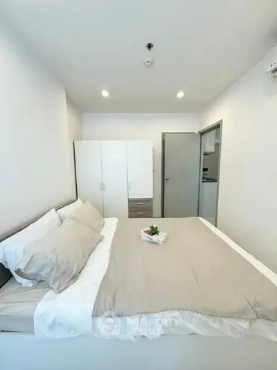 Cozy modern bedroom with neutral tones and ample storage space