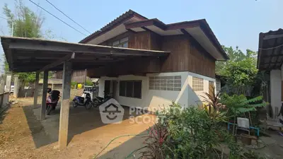 Charming rustic wooden house with spacious carport and lush greenery