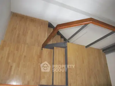 Modern wooden staircase with sleek metal railing in contemporary home