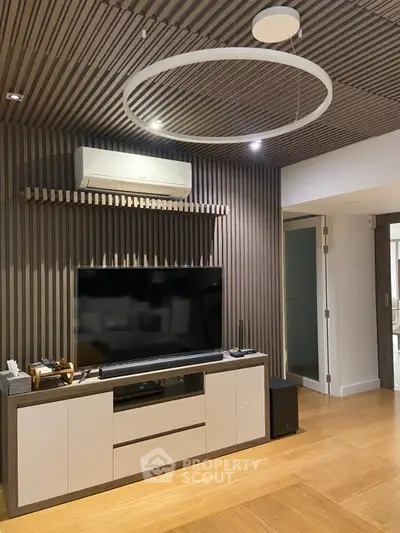 Modern living room with stylish wood paneling and sleek entertainment center