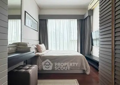 Modern bedroom with elegant decor, large window, and natural light