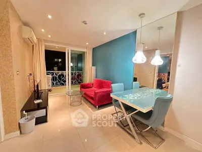 Modern living room with vibrant red sofa and elegant dining area, featuring stylish lighting and balcony access.