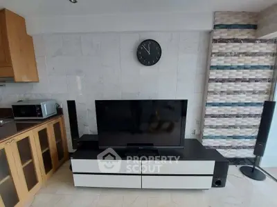 Modern living room with sleek TV setup and stylish cabinetry