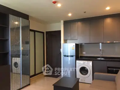 Modern apartment interior with sleek kitchen and washing machine