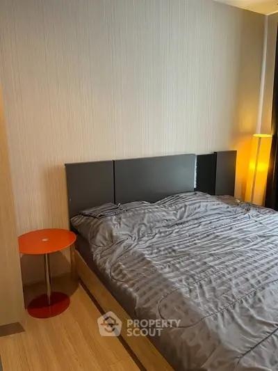 Modern bedroom with stylish decor and cozy ambiance, featuring a sleek bed and elegant lighting.