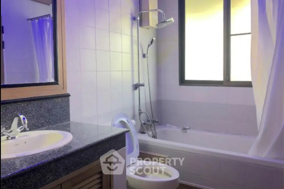 Modern bathroom with bathtub and sleek fixtures in a well-lit space.