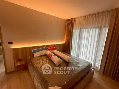 Modern bedroom with cozy lighting and large window, showcasing a stylish and inviting atmosphere.