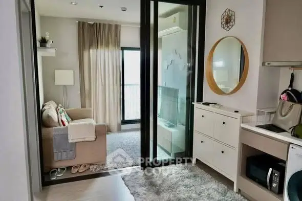 Chic modern living room with cozy sofa and stylish decor in a compact apartment.