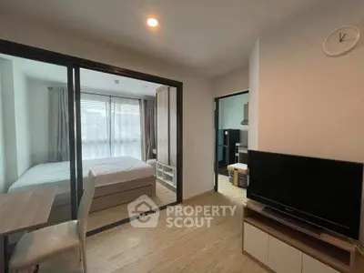 Modern apartment interior with cozy bedroom and living area, featuring sleek design and natural light.