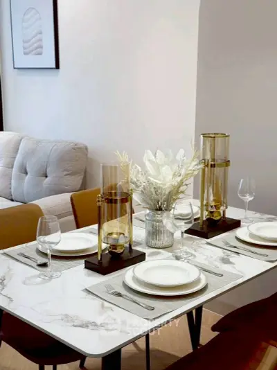 Elegant dining area with modern decor and stylish table setting in a cozy living space.