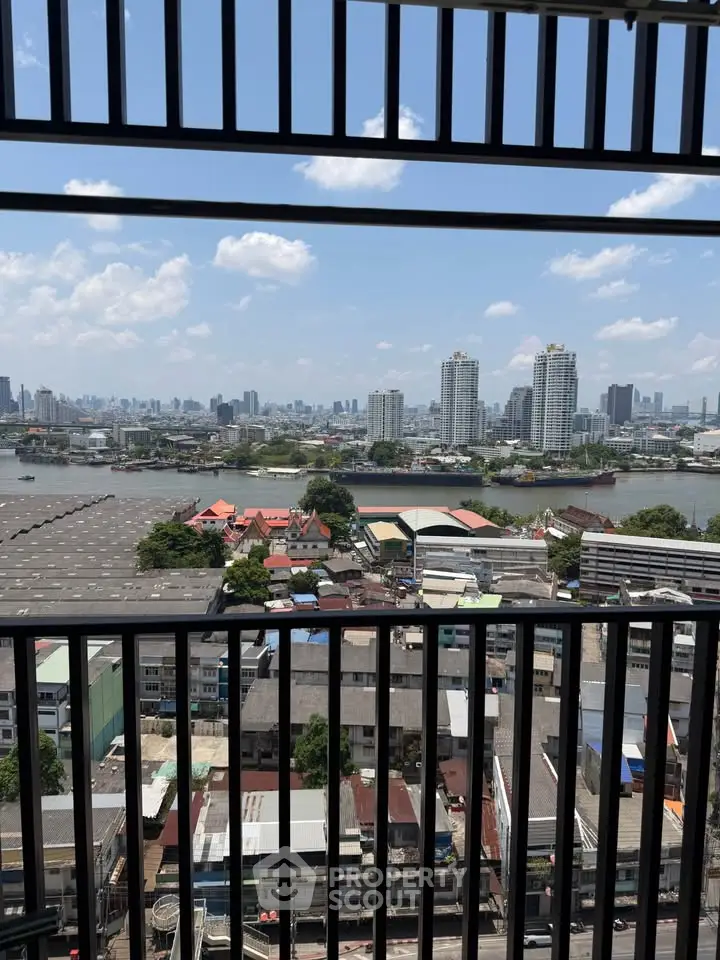 Stunning cityscape view from a high-rise balcony overlooking a river and urban skyline.
