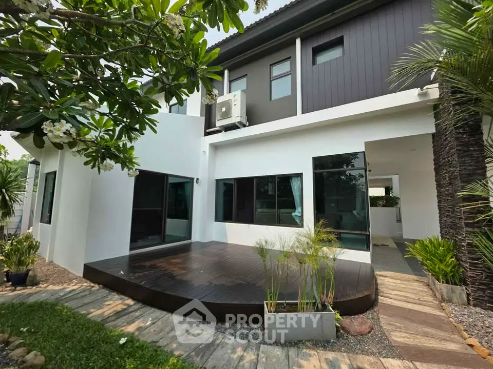 Modern two-story house with stylish exterior and lush garden