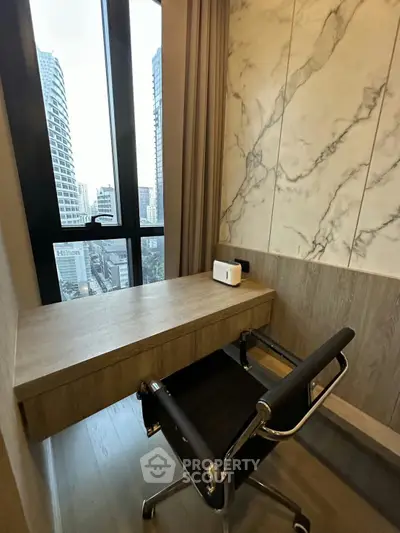 Modern study nook with city view, featuring sleek desk and chair, perfect for productivity.