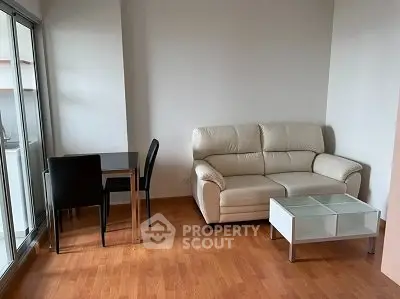 Modern living room with leather sofa and dining set on wooden floor