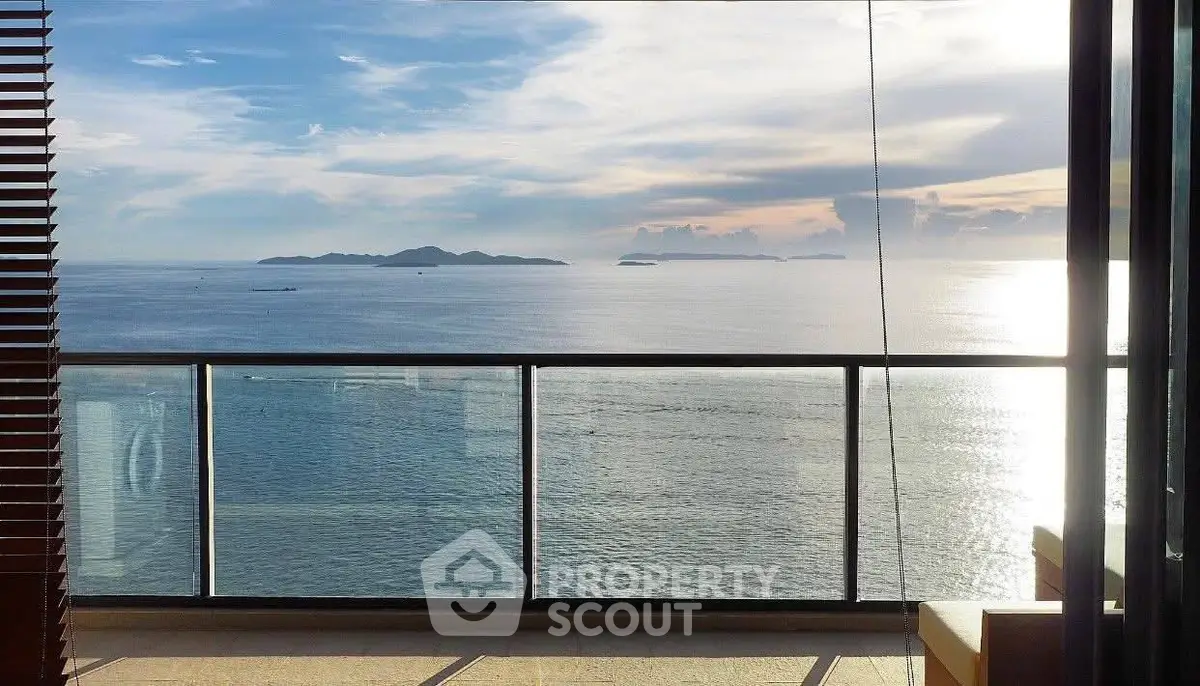 Stunning ocean view from a modern balcony with glass railing, perfect for serene living.
