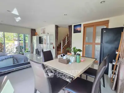 Spacious open-plan living area with dining set and modern decor