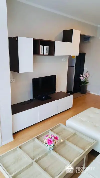 Modern living room with sleek TV unit and cozy seating area