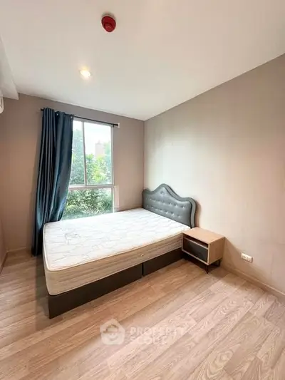 Modern bedroom with stylish bed and natural light from large window