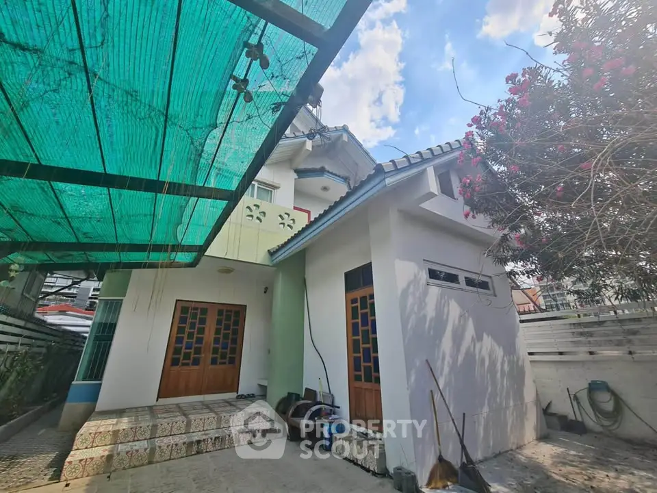 Charming suburban home with unique architectural design and spacious outdoor area.