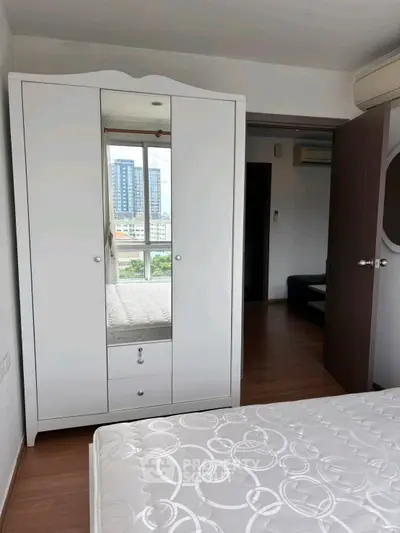 Spacious bedroom with modern wardrobe and city view window