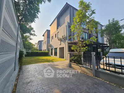 Modern townhouse with spacious driveway and lush greenery