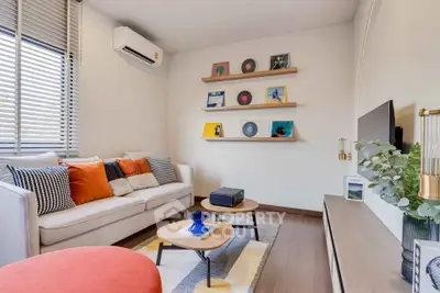 Stylish living room with modern decor and wall-mounted shelves displaying records.