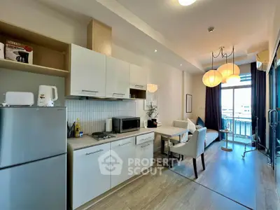 Modern open-plan kitchen and living area with balcony view