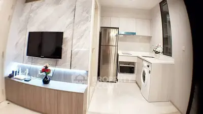 Modern kitchen with sleek appliances and stylish cabinetry in a contemporary apartment.