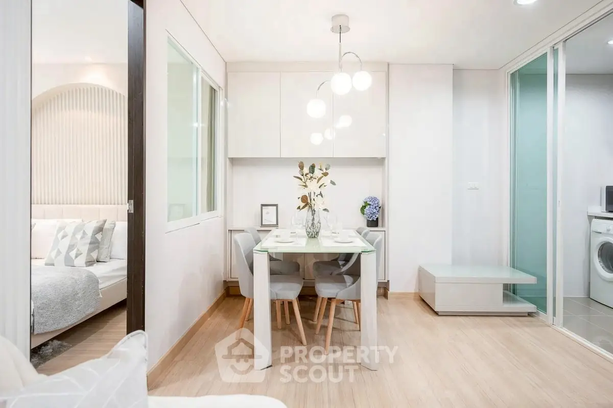 Modern dining area with elegant lighting and adjacent bedroom view