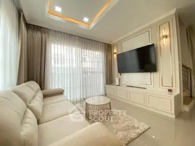 Luxurious living room with elegant decor, large sofa, and wall-mounted TV, perfect for relaxation and entertainment.
