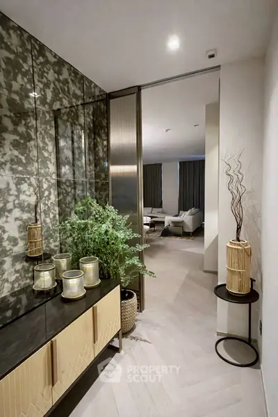 Stylish hallway leading to a modern living room with elegant decor and ambient lighting.