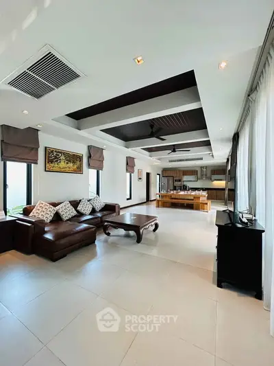 Spacious open-plan living room with modern kitchen and elegant decor