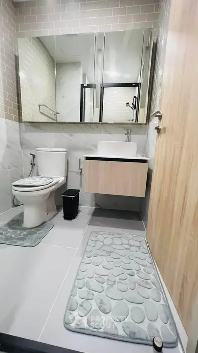 Modern bathroom with sleek fixtures and stylish decor in a contemporary apartment.