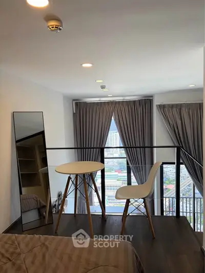 Modern loft bedroom with city view, featuring stylish furniture and floor-to-ceiling windows.