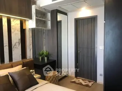 Modern bedroom with stylish decor and mirrored wardrobe