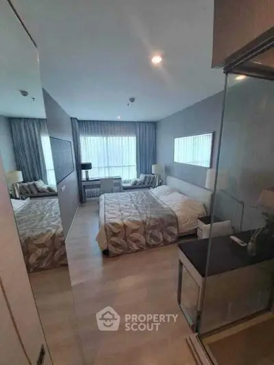 Modern bedroom with stylish decor and large window for natural light