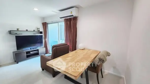 Modern living room with wooden table and TV setup, ideal for cozy gatherings.