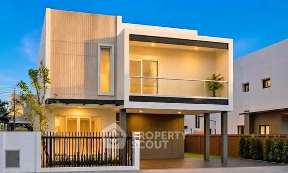 Modern two-story house with sleek design and spacious balcony, perfect for contemporary living.