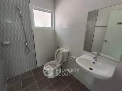 Modern bathroom with sleek fixtures and tiled shower area