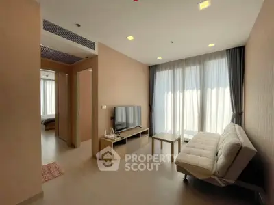 Modern living room with natural light, sleek furniture, and cozy ambiance in a stylish apartment.