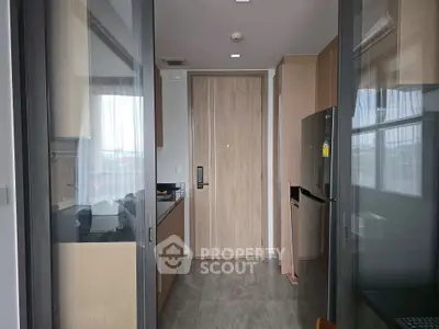 Modern kitchen with sleek design and stainless steel appliances in a compact layout.