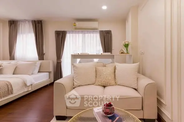 Cozy living room with elegant decor and natural light in modern apartment.