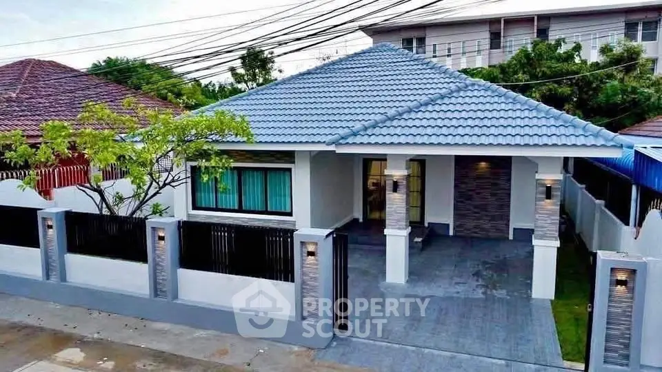 Charming single-story home with modern roof and gated entrance in a serene neighborhood.