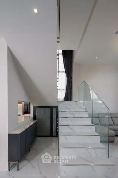 Modern interior with sleek staircase and elegant living area
