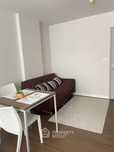 Cozy living room with modern furniture and wooden flooring, perfect for relaxation and entertaining guests.