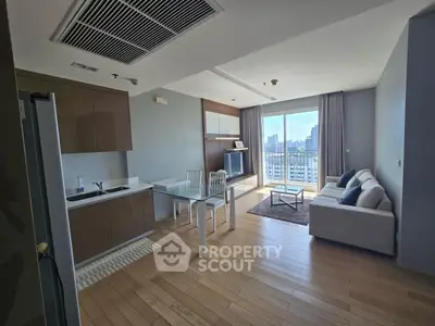 Modern open-plan living room with kitchen and city view balcony