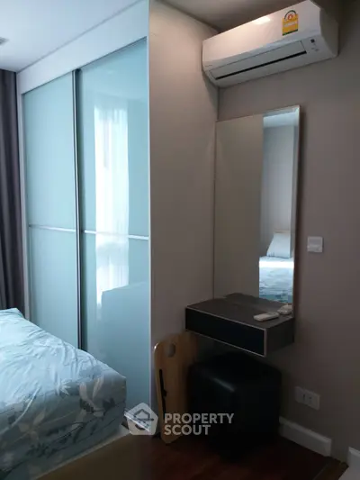 Modern bedroom with sliding closet doors and air conditioning unit