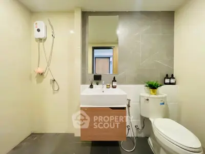 Modern bathroom with sleek fixtures and stylish decor in a contemporary apartment.