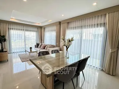 Spacious modern living room with elegant dining area and large windows